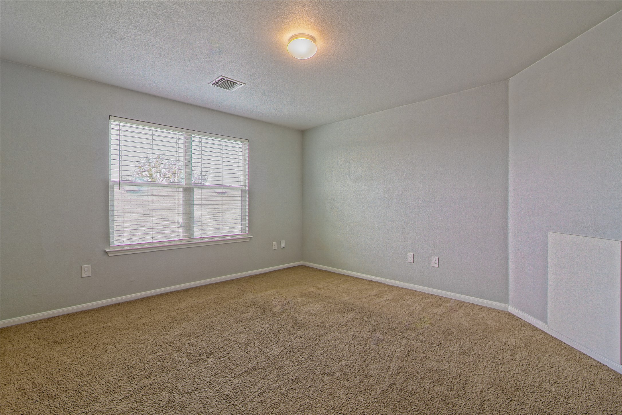 3408 Tilmon Ln. Austin, TX 78725 - Photo 23 of 35 Carpeted spare room with baseboards and a textured ceiling