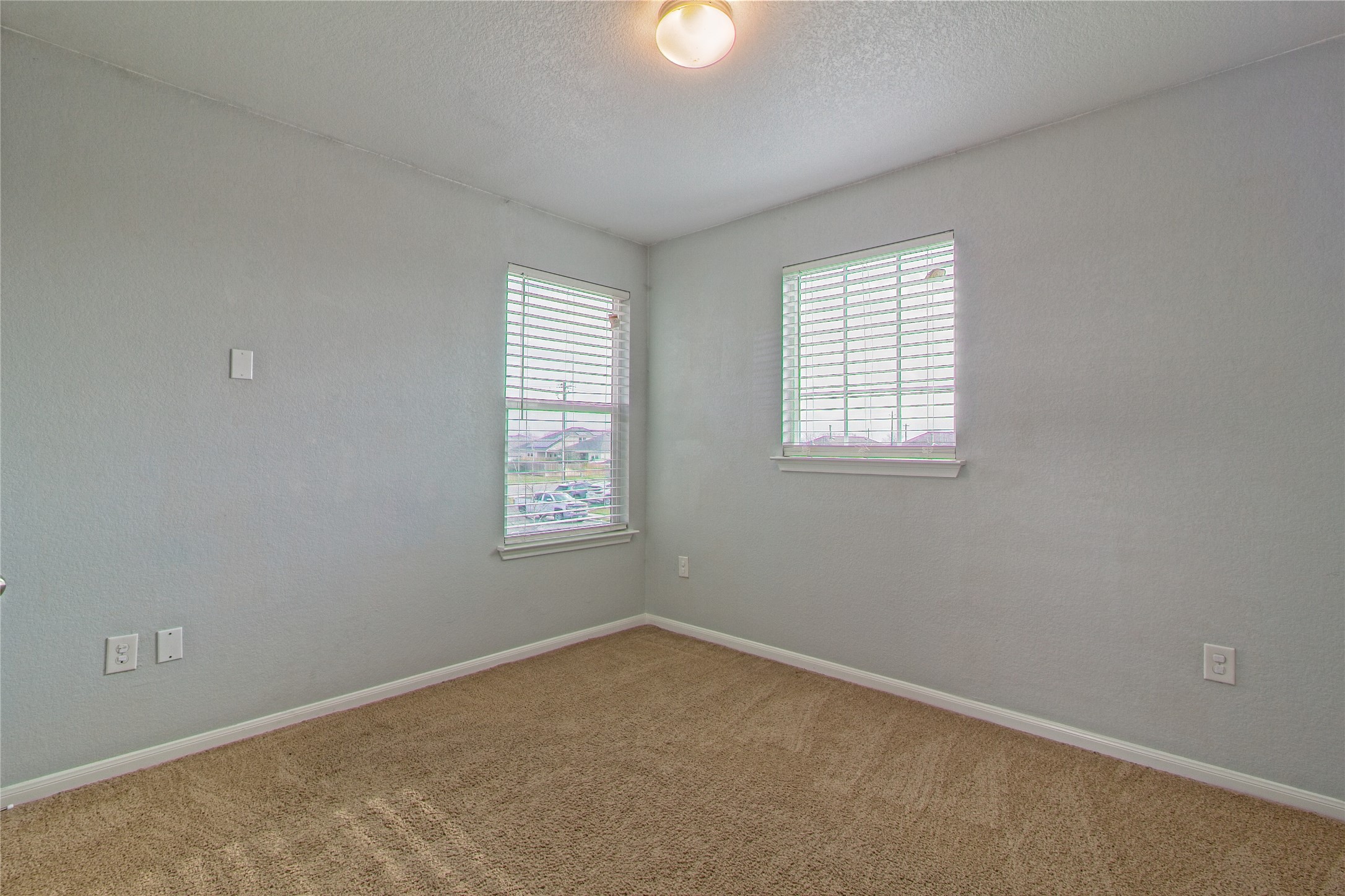 3408 Tilmon Ln. Austin, TX 78725 - Photo 25 of 35 Carpeted spare room featuring plenty of natural light and a textured ceiling