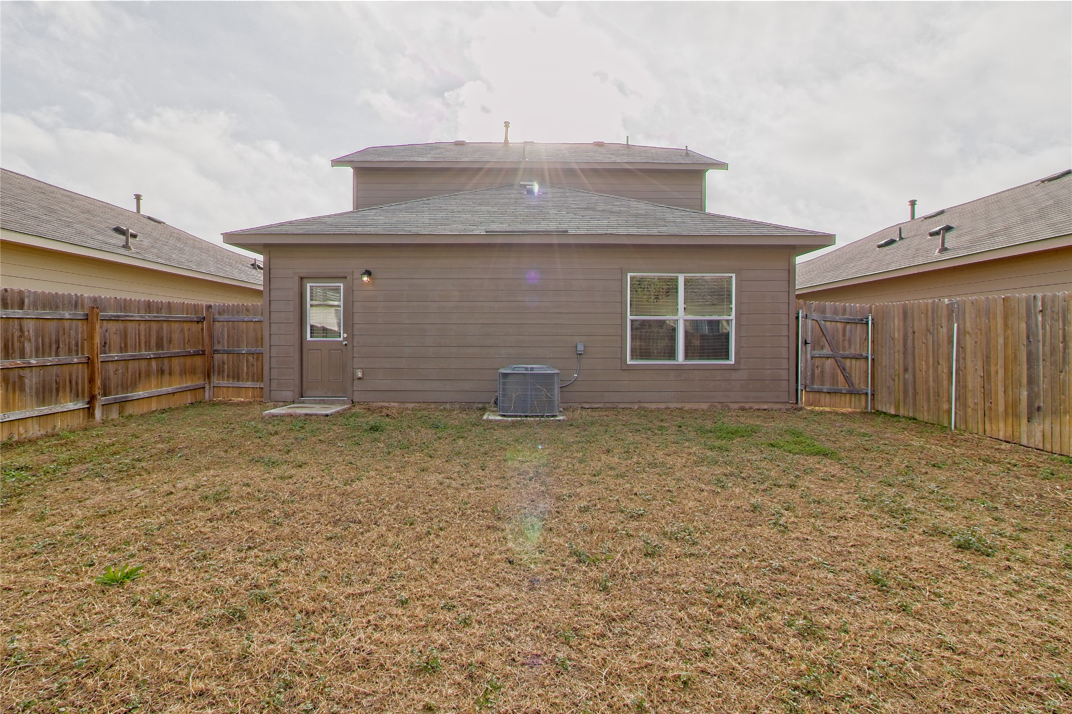 3408 Tilmon Ln. Austin, TX 78725 - Photo 28 of 35 Back of property with a gate and a fenced backyard