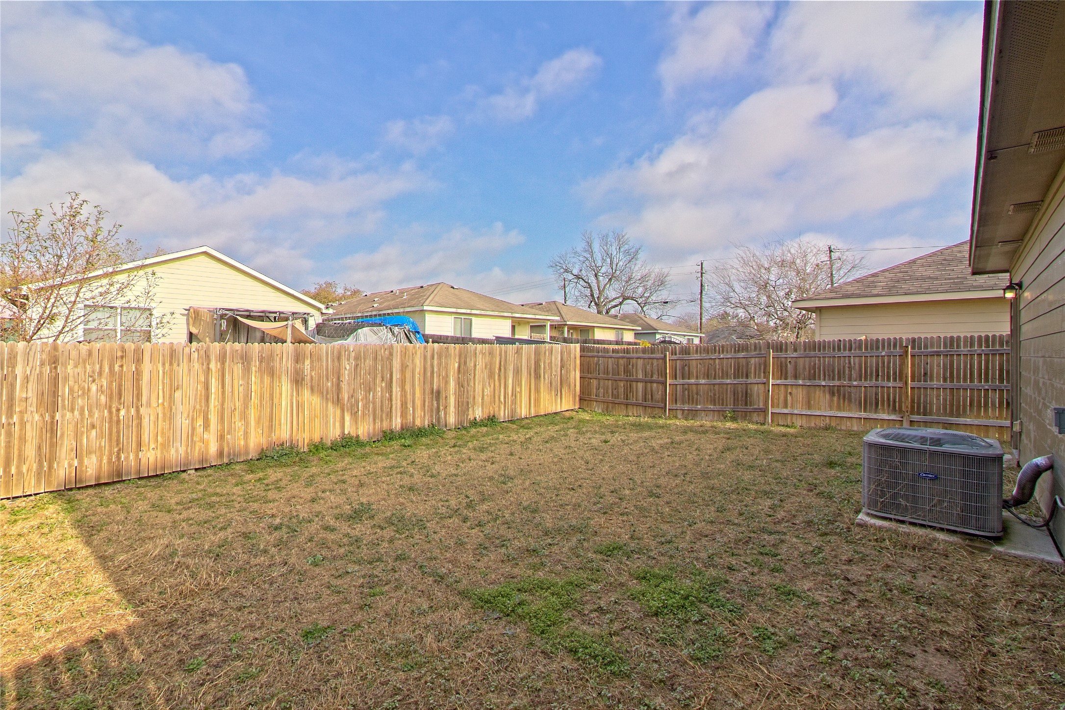 3408 Tilmon Ln. Austin, TX 78725 - Photo 29 of 35 Fenced backyard with a residential view