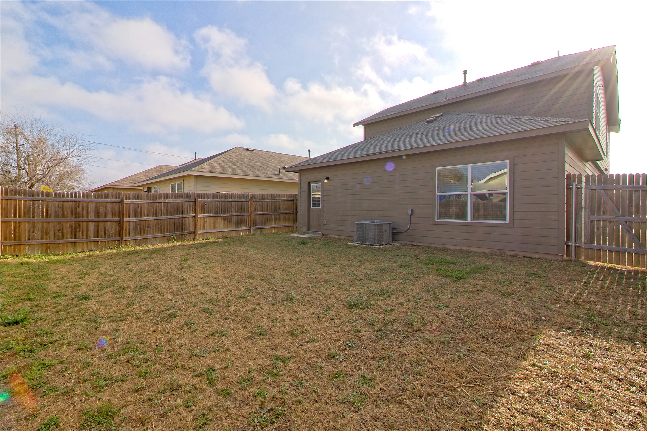 3408 Tilmon Ln. Austin, TX 78725 - Photo 30 of 35 Rear view of property featuring a fenced backyard
