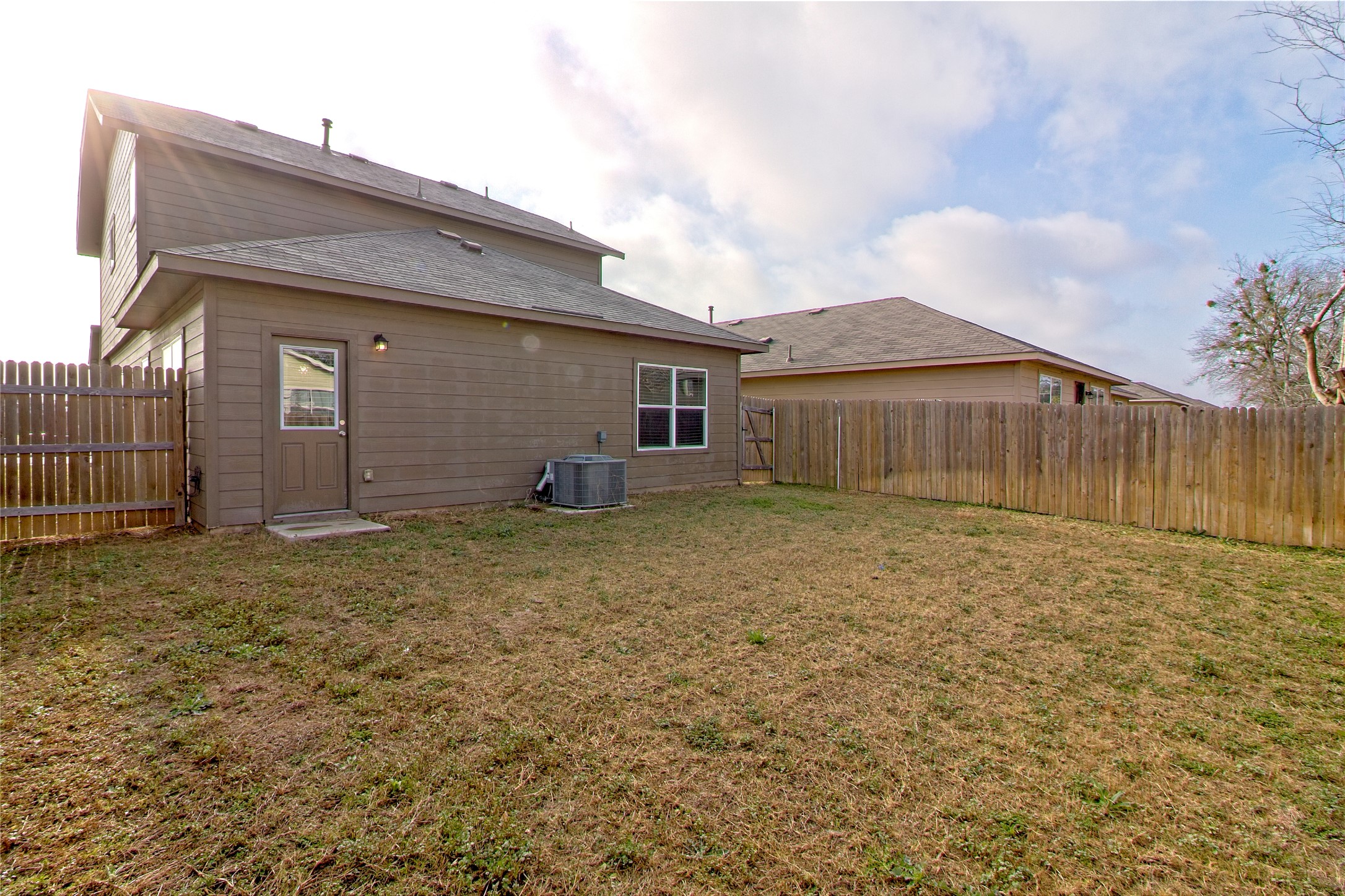 3408 Tilmon Ln. Austin, TX 78725 - Photo 32 of 35 Rear view of house featuring a fenced backyard