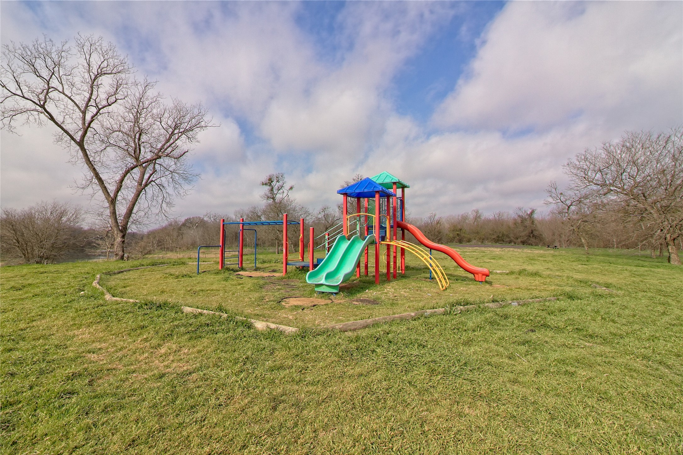 3408 Tilmon Ln. Austin, TX 78725 - Photo 35 of 35 Communal playground featuring a lawn