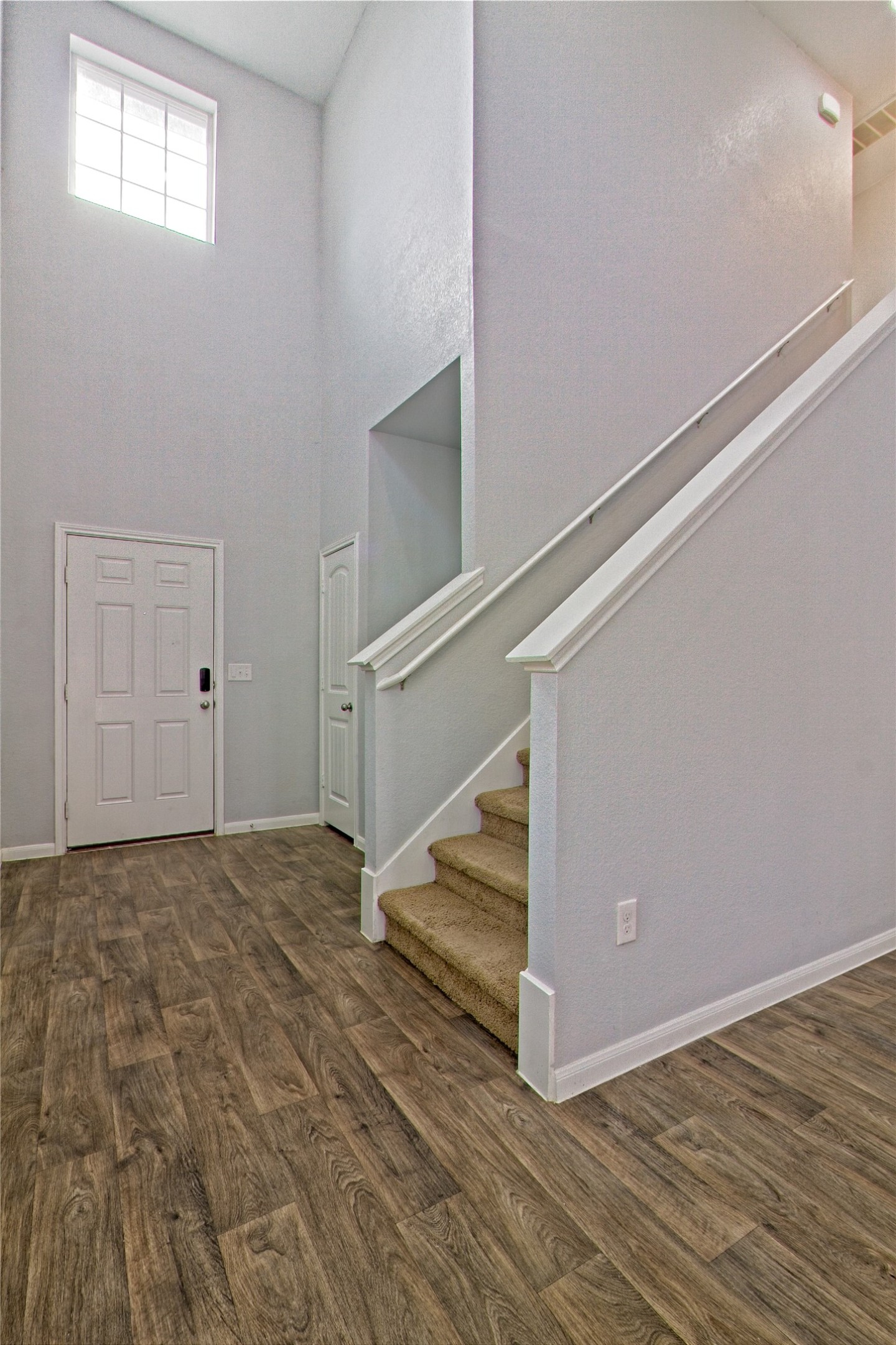 3408 Tilmon Ln. Austin, TX 78725 - Photo 5 of 35 Foyer entrance featuring a high ceiling and dark wood-type flooring