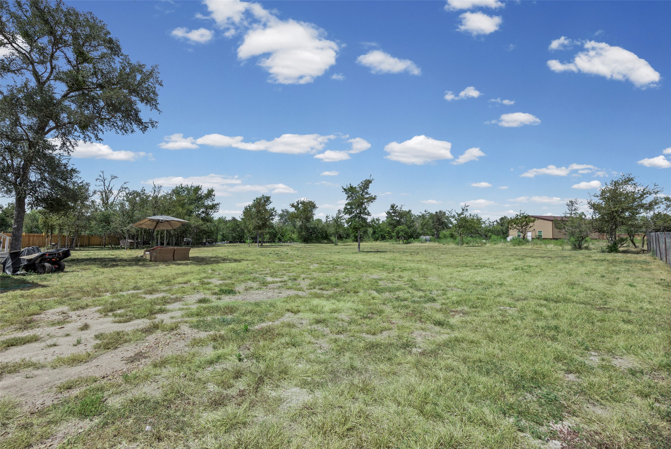 120 Mimosa Road Dale, TX 78616 - Photo 20 of 21 A spacious, verdant lot awaits your vision, framed by mature trees and a tranquil sky.