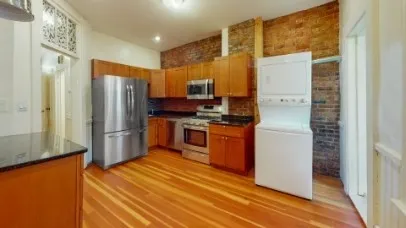 a kitchen with stainless steel appliances a refrigerator and a stove top oven