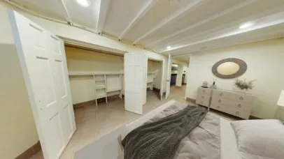 a bedroom with a bed and cabinets