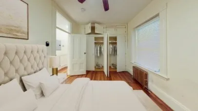 a bedroom with a bed and a chandelier