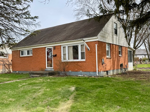 4733 Curtis Drive Springfield, OH 45503 - Photo 1 of 50 This classic brick bungalow offers a cozy and inviting exterior with a sloped roof.