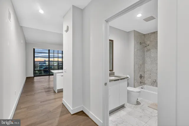 a bathroom with a double vanity sink toilet and shower