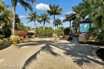 4991 Coach Lane Naples, FL 34114 - Photo 6 of 8 a view of a street with palm trees