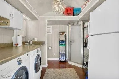 a view of washer and dryer with kitchen in the background