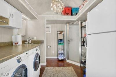 4991 Coach Lane Naples, FL 34114 - Photo 8 of 8 a view of washer and dryer with kitchen in the background