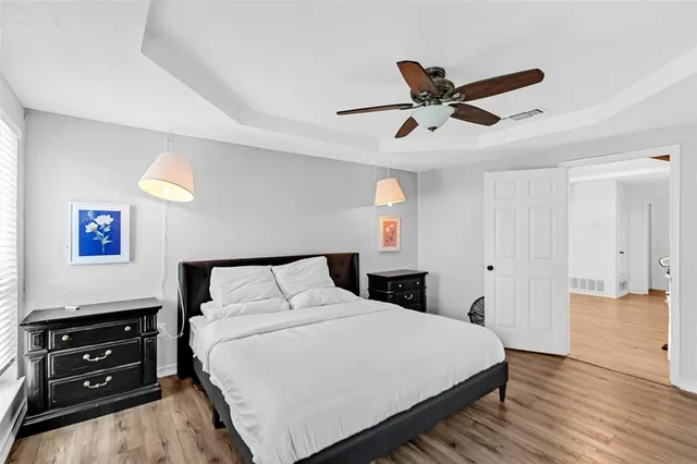 a bedroom with a bed and a ceiling fan