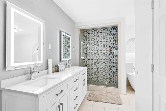 a bathroom with a shower a sink and a mirror