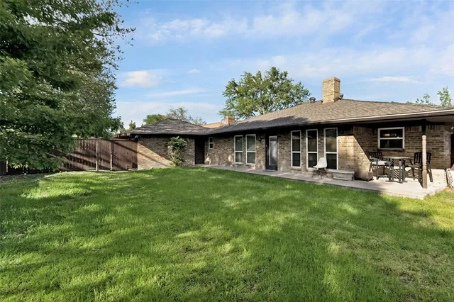 a view of a house with a yard balcony and furniture