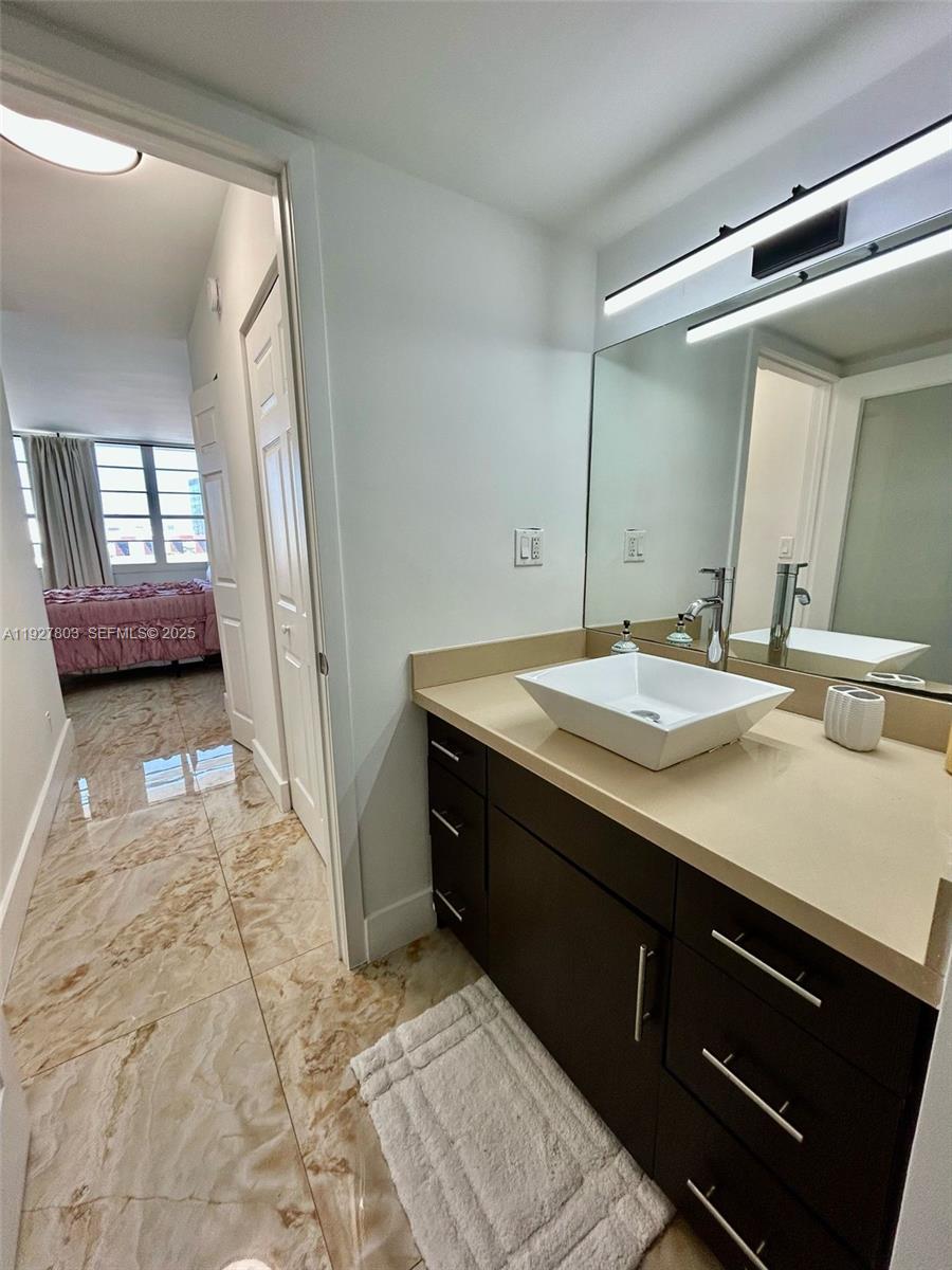 100 Lincoln Road, Unit 722 Miami Beach, FL 33139 - Photo 11 of 17 a bathroom with a sink and a mirror