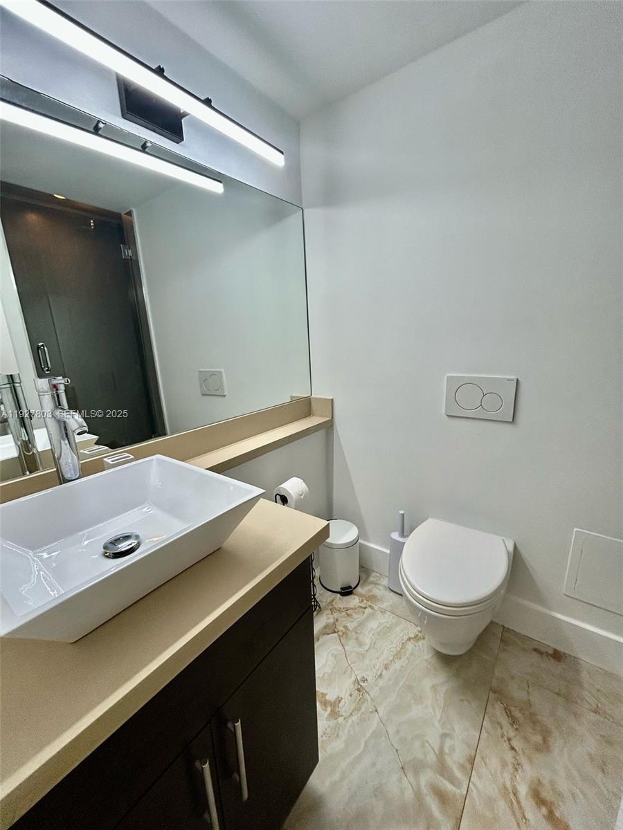 100 Lincoln Road, Unit 722 Miami Beach, FL 33139 - Photo 12 of 17 a bathroom with a granite countertop sink and a mirror