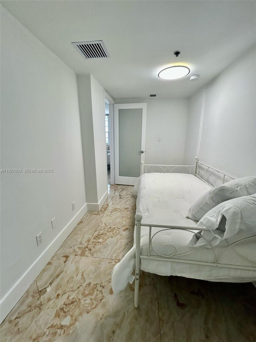 100 Lincoln Road, Unit 722 Miami Beach, FL 33139 - Photo 13 of 17 a bedroom with a bed and a window