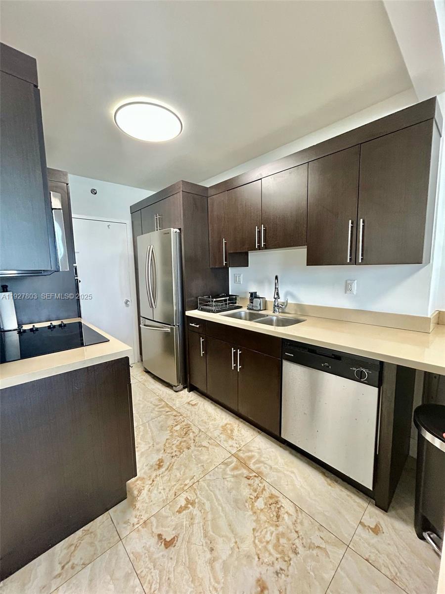 100 Lincoln Road, Unit 722 Miami Beach, FL 33139 - Photo 5 of 17 a kitchen with stainless steel appliances a sink stove and refrigerator