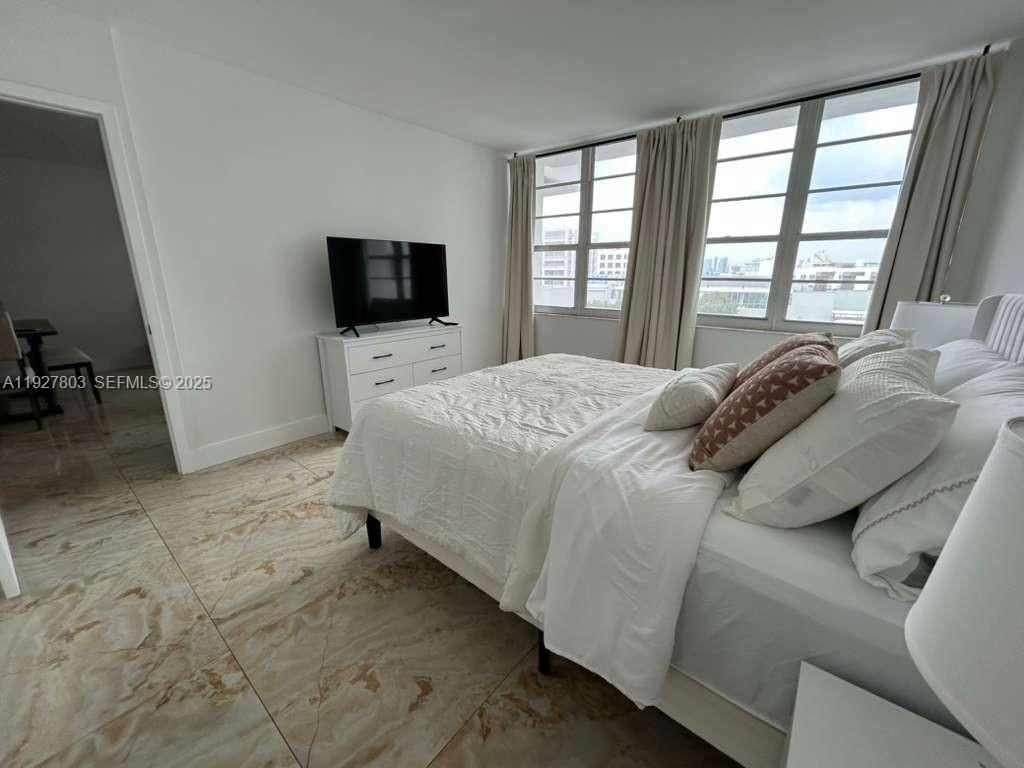 100 Lincoln Road, Unit 722 Miami Beach, FL 33139 - Photo 7 of 17 a bedroom with a bed and a television