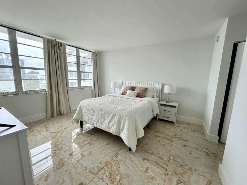 100 Lincoln Road, Unit 722 Miami Beach, FL 33139 - Photo 8 of 17 a bedroom with a bed and a window