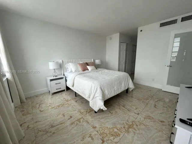 a bed sitting in a room next to a window