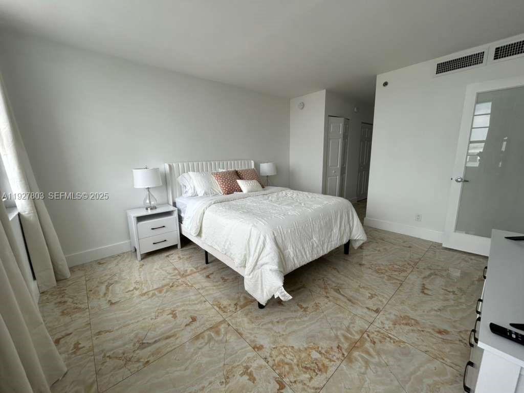 100 Lincoln Road, Unit 722 Miami Beach, FL 33139 - Photo 9 of 17 a bed sitting in a room next to a window