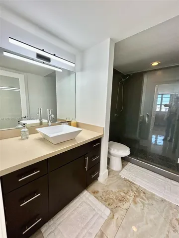 a bathroom with a sink double vanity and a mirror