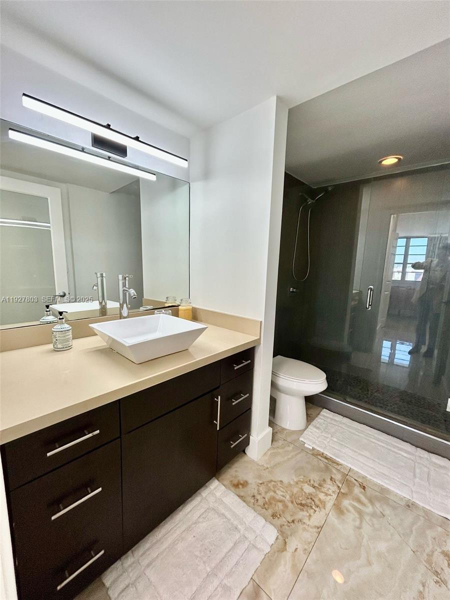 100 Lincoln Road, Unit 722 Miami Beach, FL 33139 - Photo 10 of 17 a bathroom with a sink double vanity and a mirror