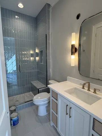 a bathroom with a sink toilet and shower