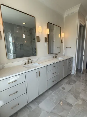 a bathroom with a double vanity sink mirror and double