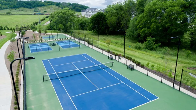 a view of a tennis ground with a swimming pool