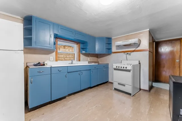 a utility room with cabinets washer and dryer