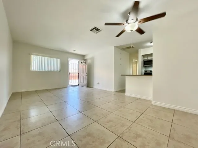 a view of a livingroom with a ceiling fan and window