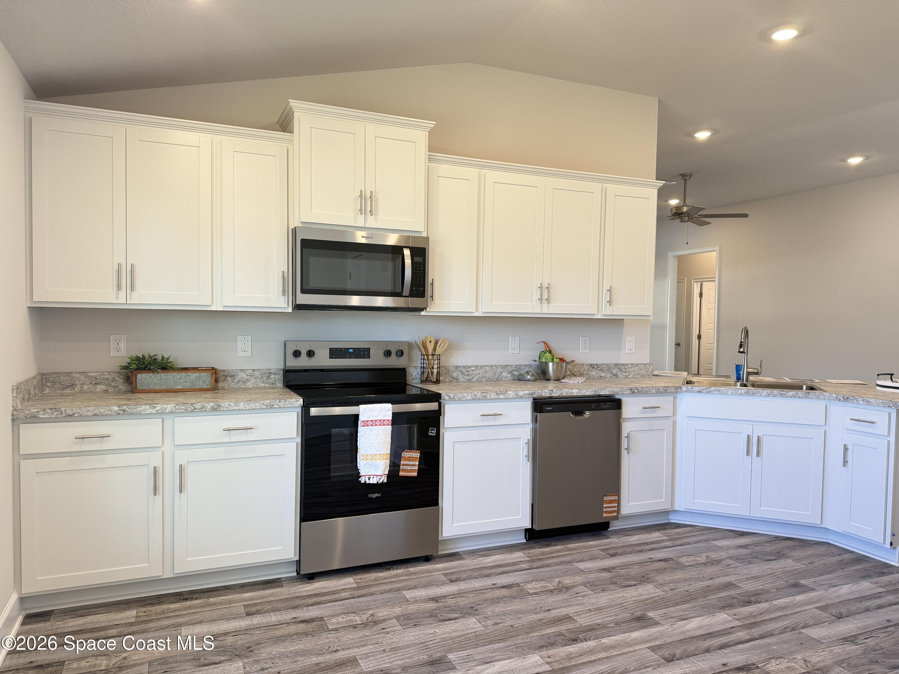 302 Quarry Lane Sebastian, FL 32958 - Photo 11 of 22 a kitchen with a sink stove and microwave