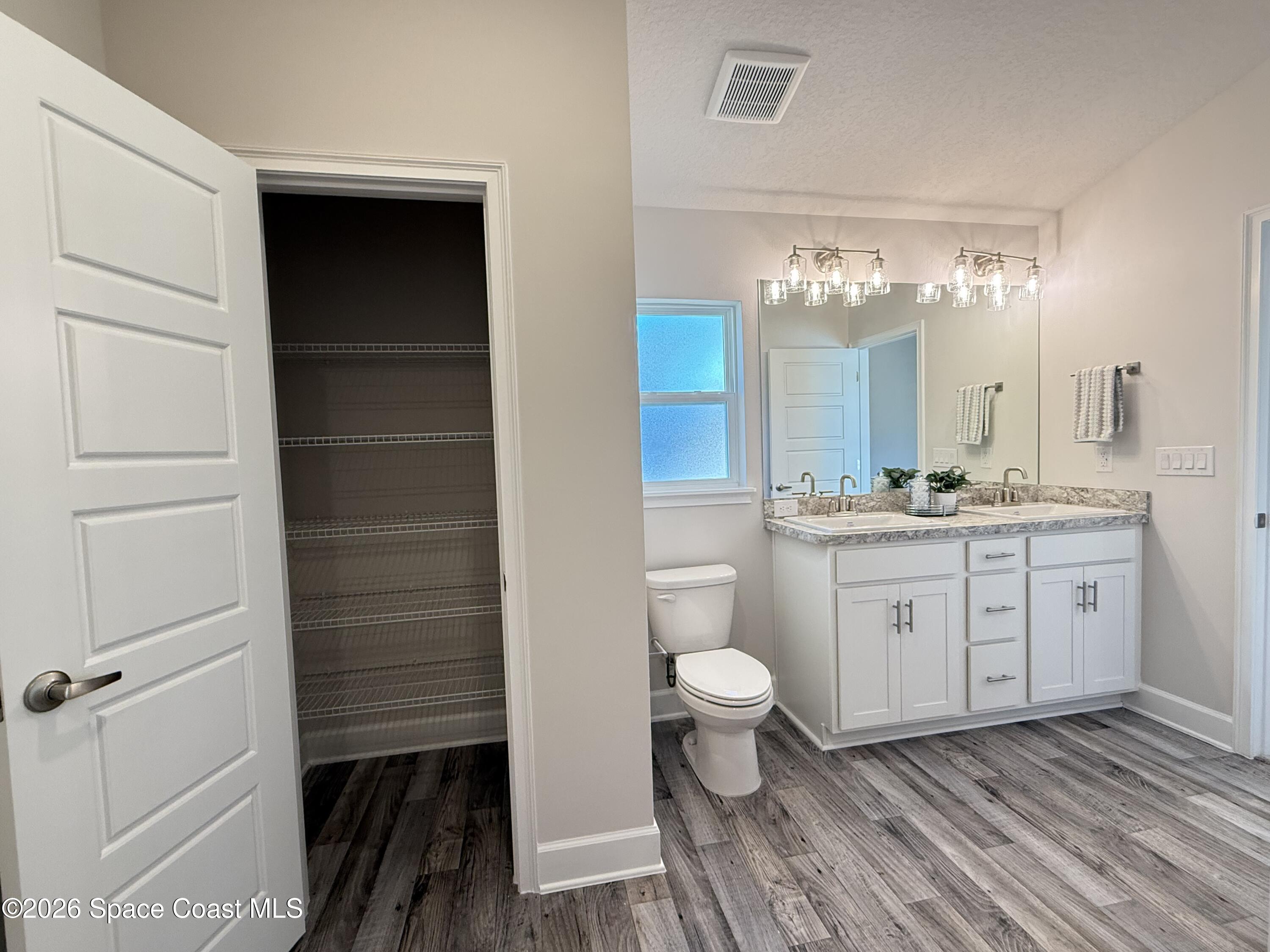 302 Quarry Lane Sebastian, FL 32958 - Photo 21 of 22 a bathroom with a sink a toilet and a mirror