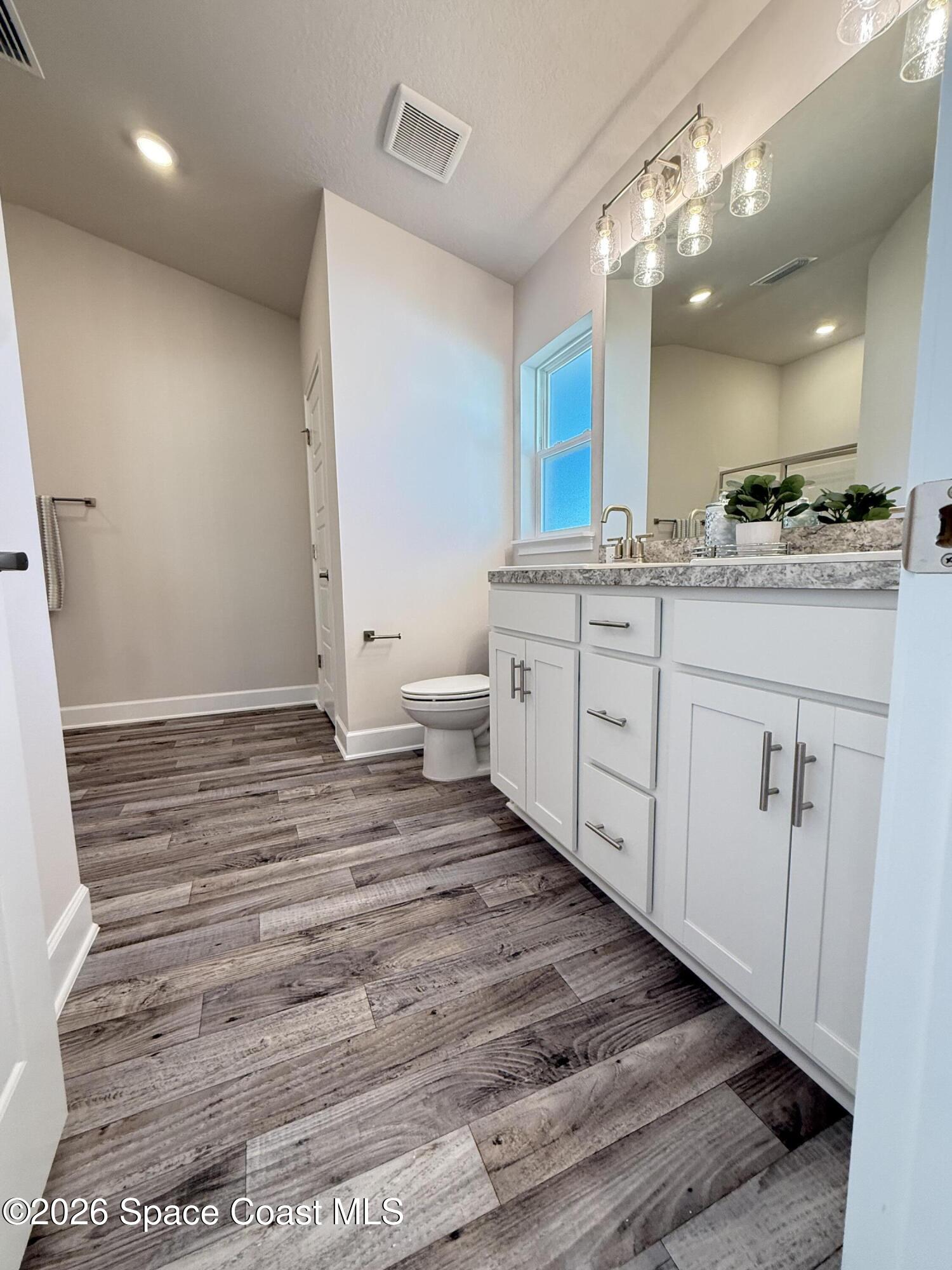 302 Quarry Lane Sebastian, FL 32958 - Photo 3 of 22 a bathroom with a sink a toilet and a mirror