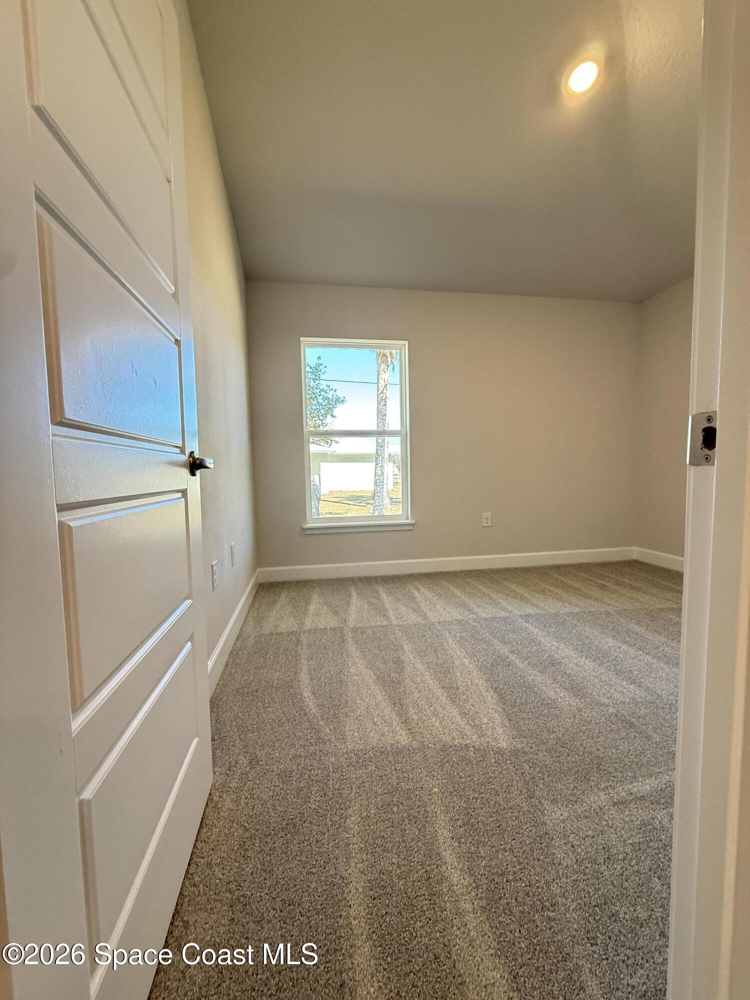 302 Quarry Lane Sebastian, FL 32958 - Photo 7 of 22 a view of an empty room with a window
