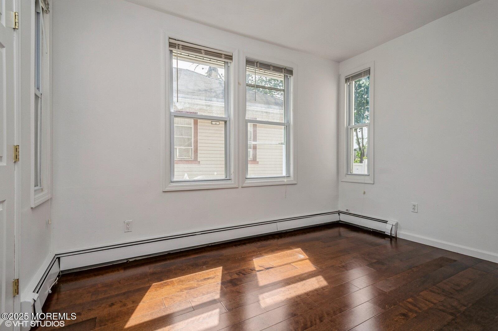 118 Joline Avenue, Unit 1 Long Branch, NJ 07740 - Photo 12 of 21 a view of a room with wooden floor and windows