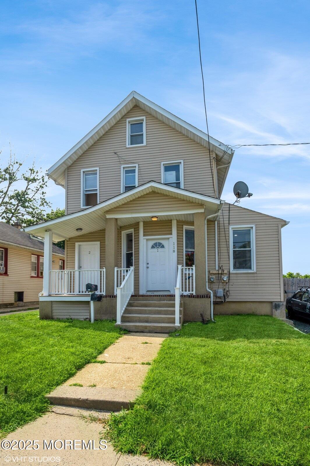 118 Joline Avenue, Unit 1 Long Branch, NJ 07740 - Photo 3 of 21 a front view of a house with a yard