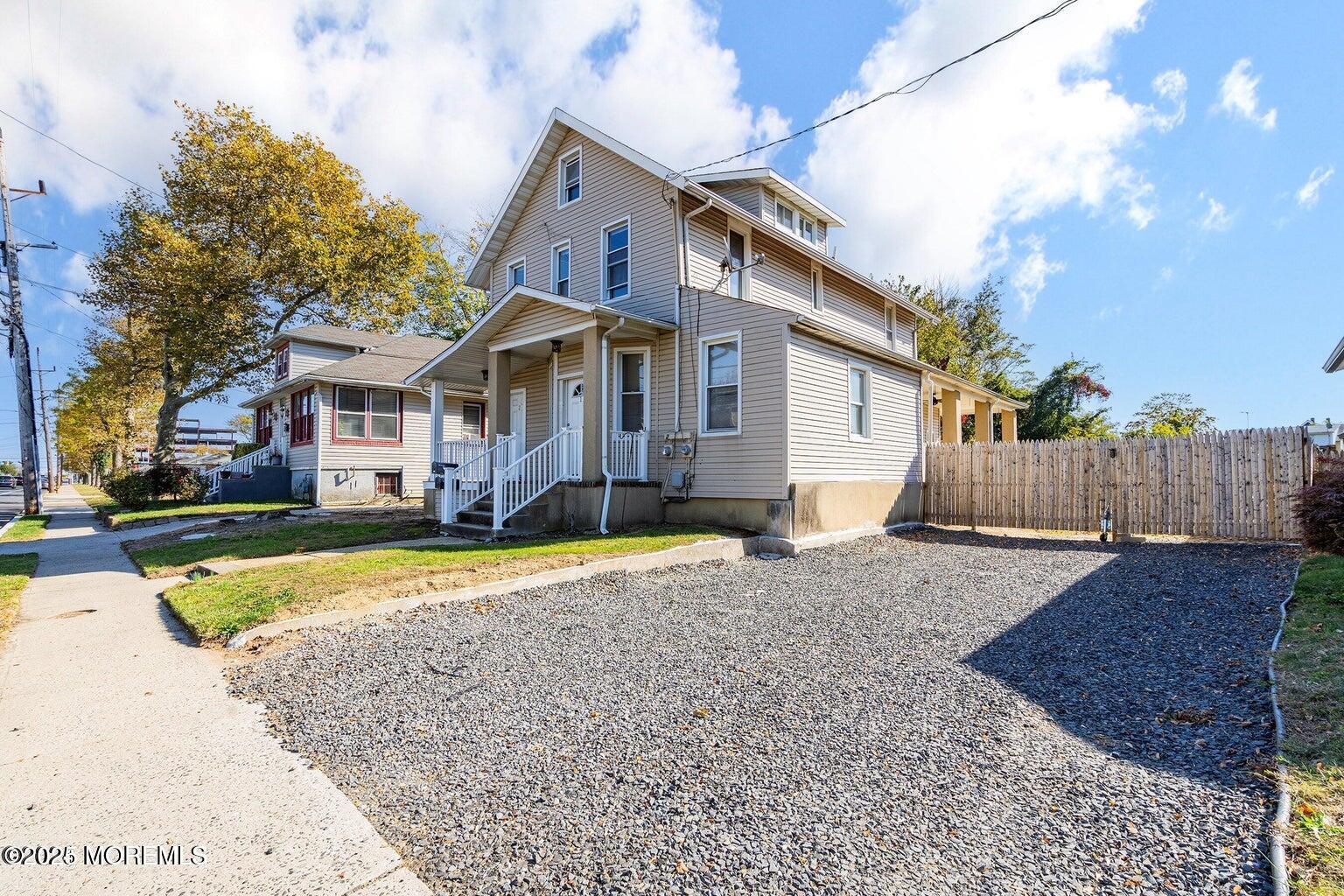 118 Joline Avenue, Unit 1 Long Branch, NJ 07740 - Photo 5 of 21 a front view of a house with a yard and garage