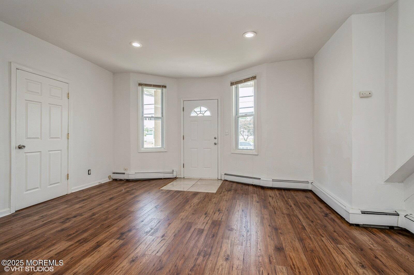 118 Joline Avenue, Unit 1 Long Branch, NJ 07740 - Photo 8 of 21 an empty room with wooden floor and windows