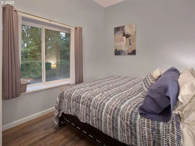 a bedroom with a bed and window
