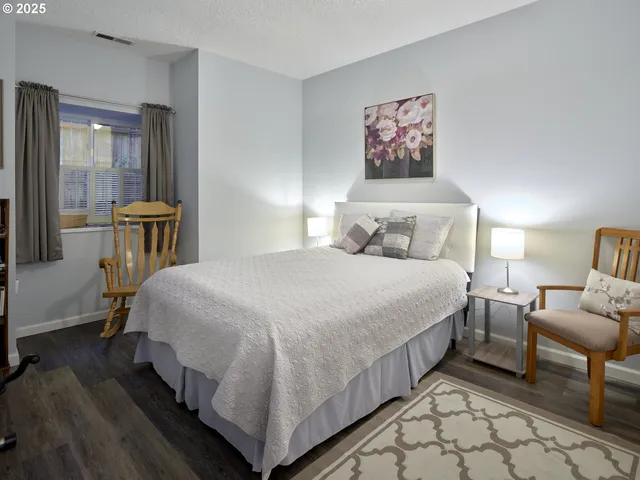 a bedroom with bed and a chandelier