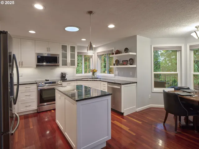 a kitchen with a stove a sink and a refrigerator
