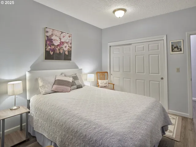 a bedroom with a large bed and a chandelier