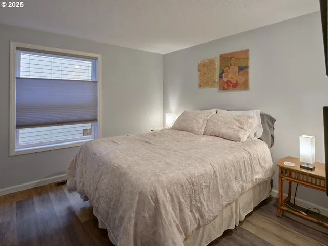 a large bed sitting in a bedroom next to a window