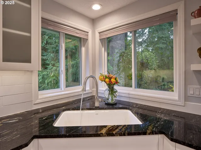 a bathroom with a tub sink and window