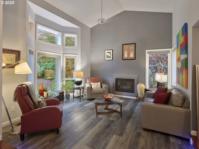 a living room with furniture wooden floor and a fireplace